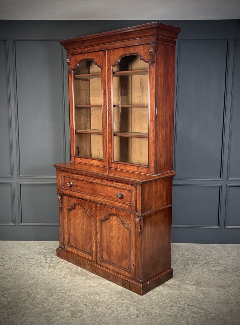 A tall Victorian mahogany secretaire bookcase featuring an upper two-door glazed cabinet over a writing drawer and lower cupboard base. View X