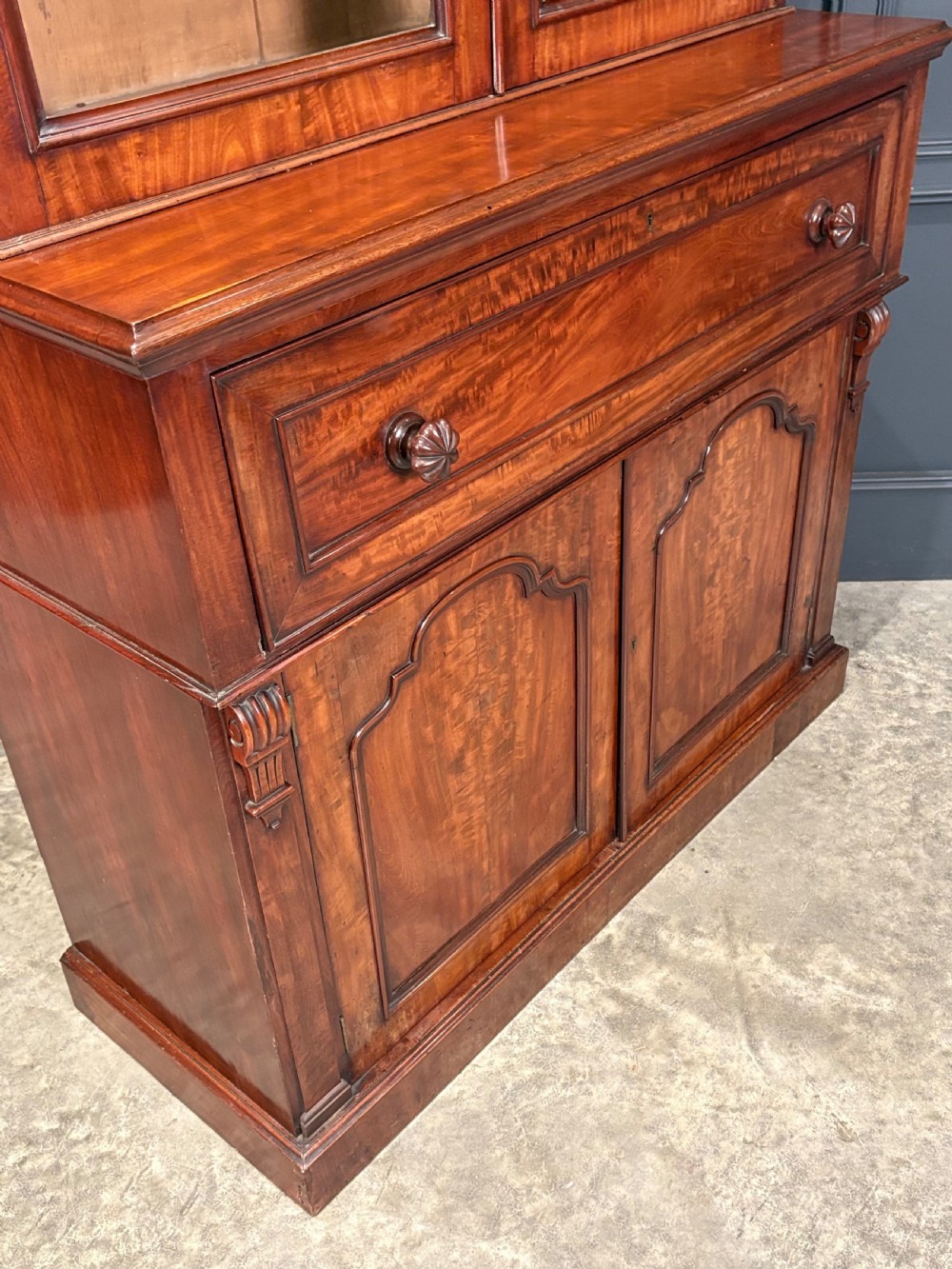 A tall Victorian mahogany secretaire bookcase featuring an upper two-door glazed cabinet over a writing drawer and lower cupboard base. View XVIII