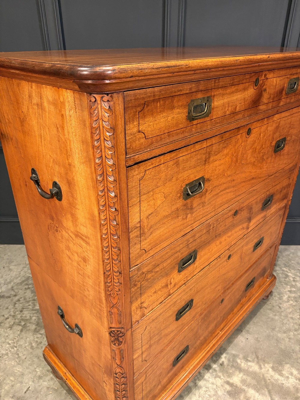 A 19th-century camphor wood campaign secretaire chest featuring a two-part split construction with flush brass handles, side carrying handles, and carved pilasters. View III