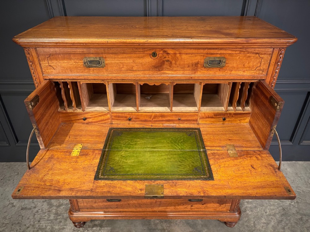 A 19th-century camphor wood campaign secretaire chest featuring a two-part split construction with flush brass handles, side carrying handles, and carved pilasters. View VI