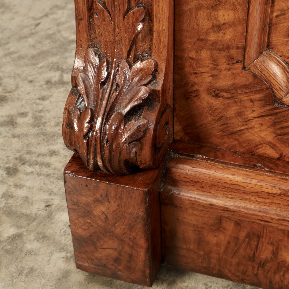 A Victorian pollard oak sideboard featuring three panelled cupboard doors, carved foliage pilasters, and a moulded rectangular top. View IV