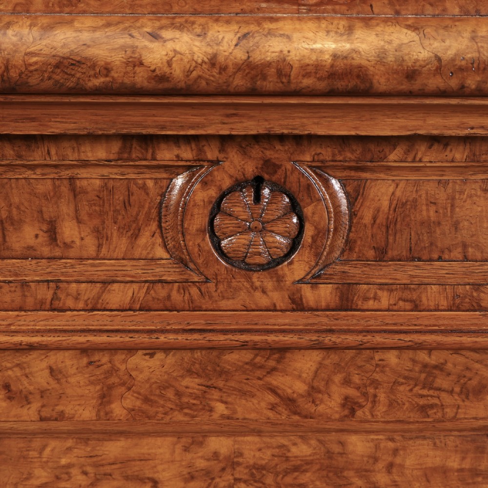 A Victorian pollard oak sideboard featuring three panelled cupboard doors, carved foliage pilasters, and a moulded rectangular top. View IX
