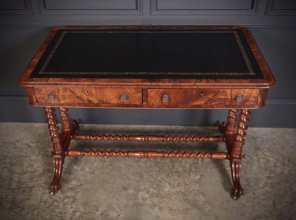 Victorian walnut library writing table with a black leather insert, barley twist legs, double spiral stretcher, and frieze drawers. View IV
