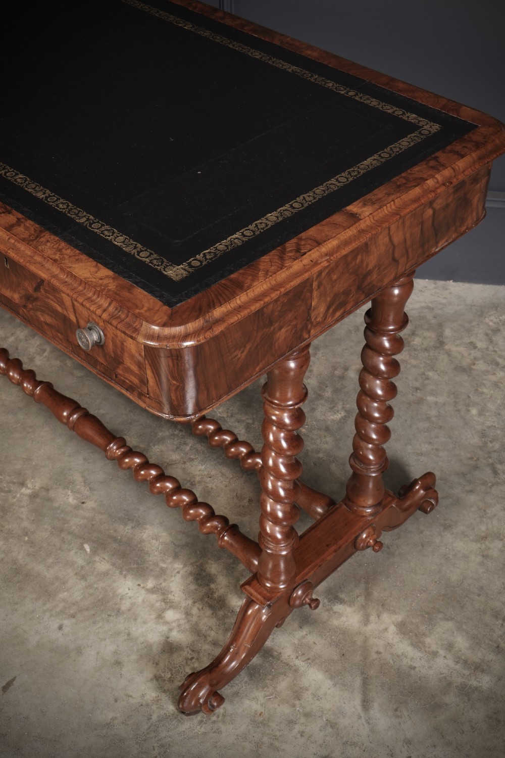 Victorian walnut library writing table with a black leather insert, barley twist legs, double spiral stretcher, and frieze drawers. View VI