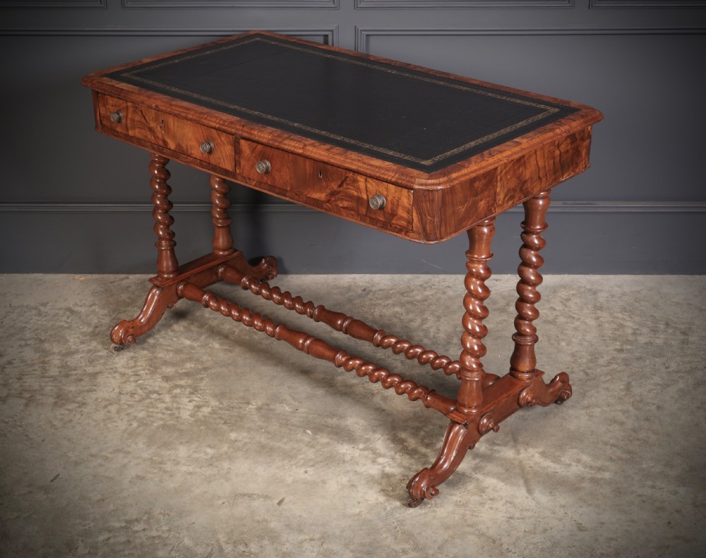 Victorian walnut library writing table with a black leather insert, barley twist legs, double spiral stretcher, and frieze drawers. View VII