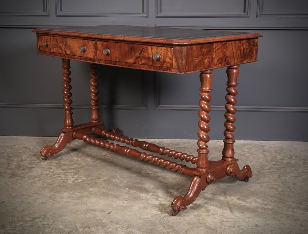 Victorian walnut library writing table with a black leather insert, barley twist legs, double spiral stretcher, and frieze drawers. View IX