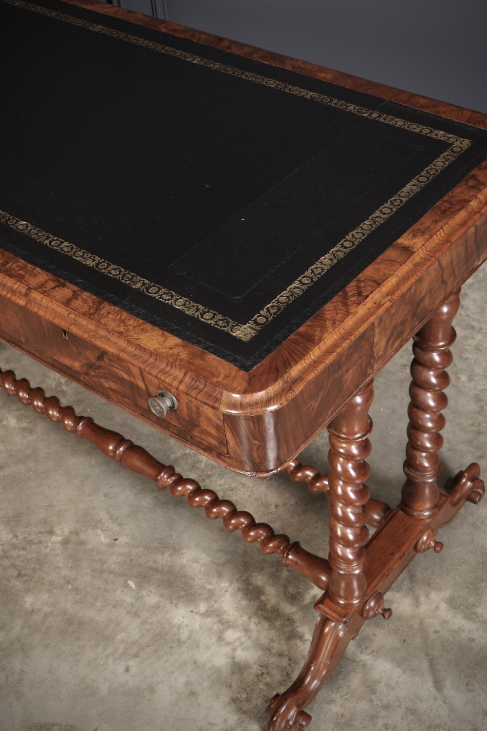 Victorian walnut library writing table with a black leather insert, barley twist legs, double spiral stretcher, and frieze drawers. View X