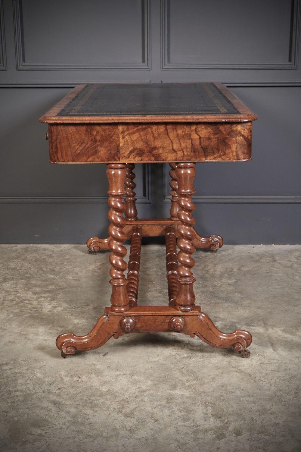 Victorian walnut library writing table with a black leather insert, barley twist legs, double spiral stretcher, and frieze drawers. View XI