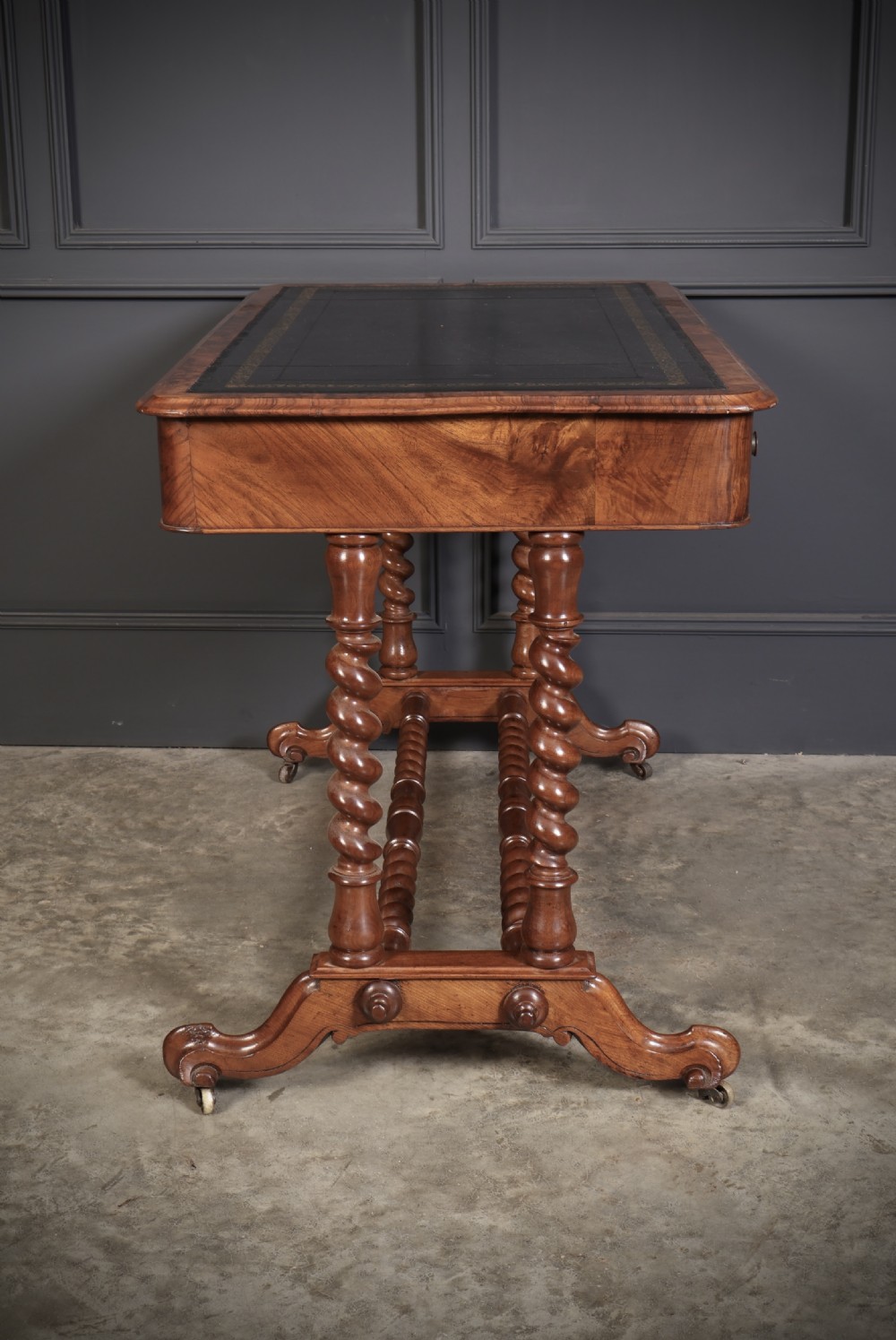 Victorian walnut library writing table with a black leather insert, barley twist legs, double spiral stretcher, and frieze drawers. View XIII
