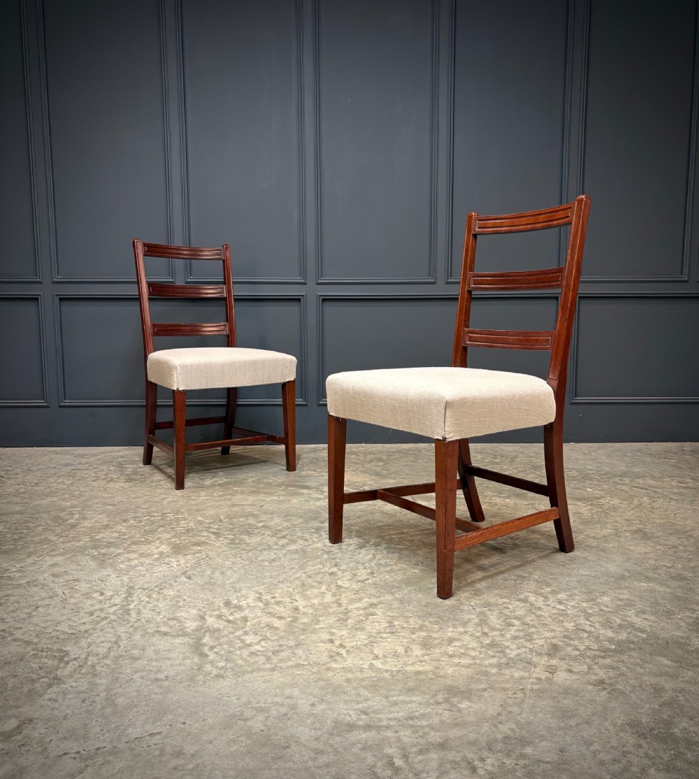 A set of eighteen Georgian mahogany dining chairs featuring triple horizontal bar backrests and light cream upholstered seats. View II