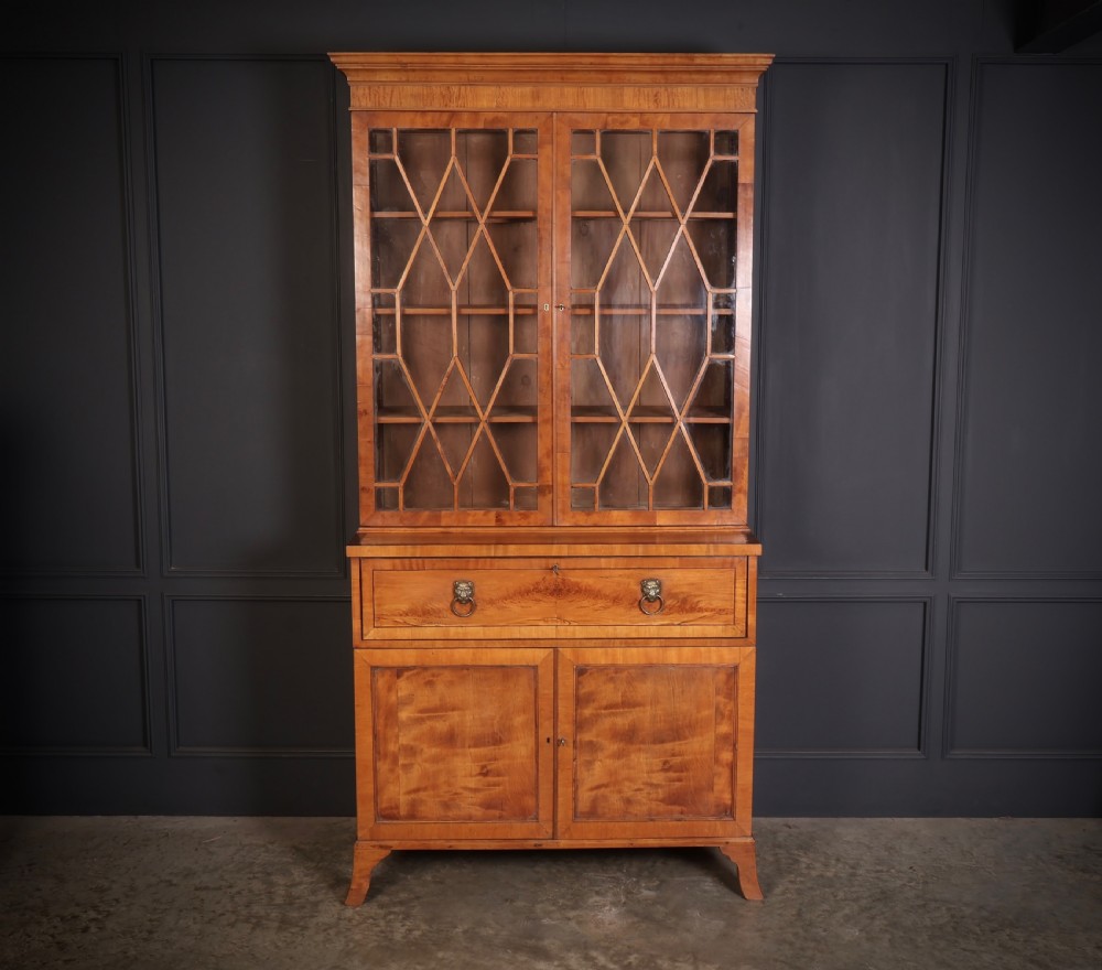 A Georgian satinwood secretaire bookcase with diamond astragal glazed doors above a lower cupboard base. View II