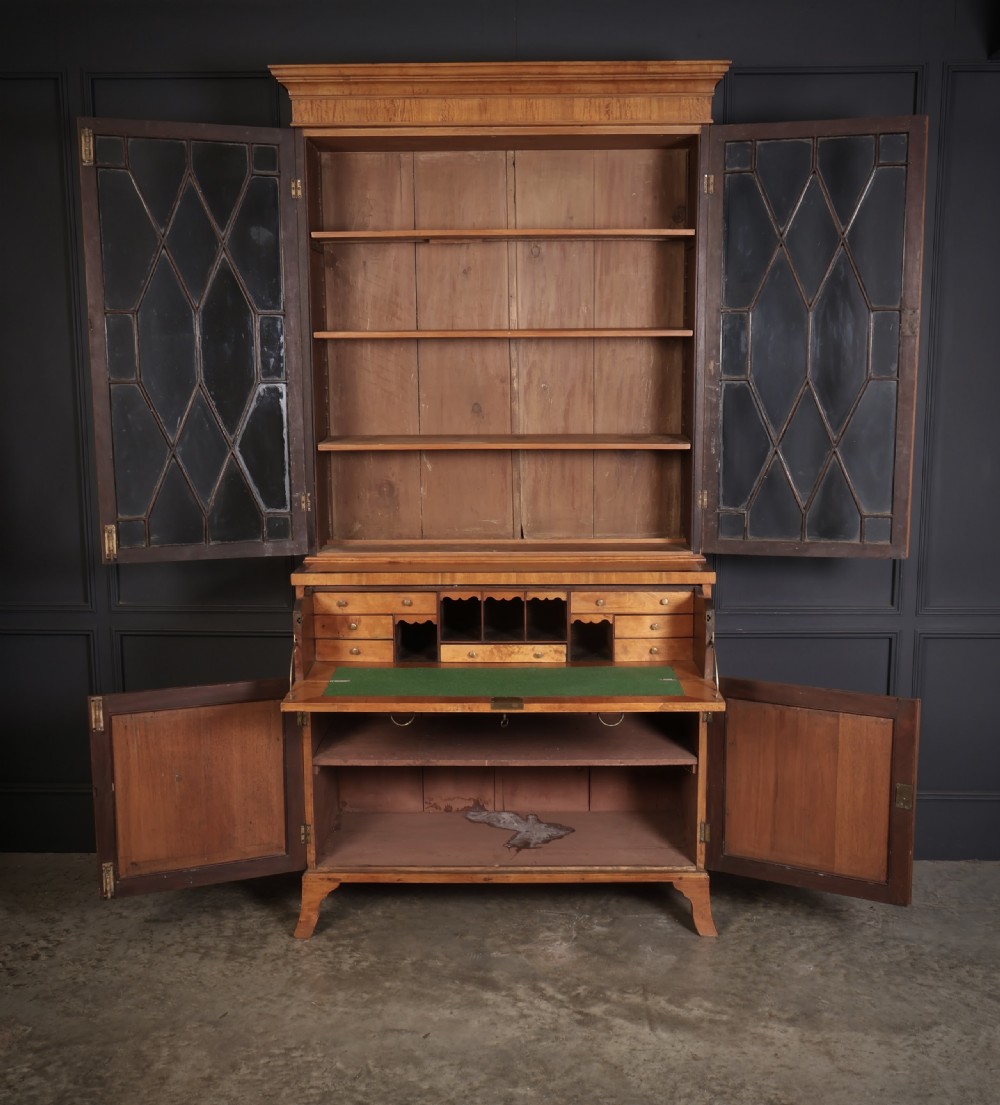 A Georgian satinwood secretaire bookcase with diamond astragal glazed doors above a lower cupboard base. View III