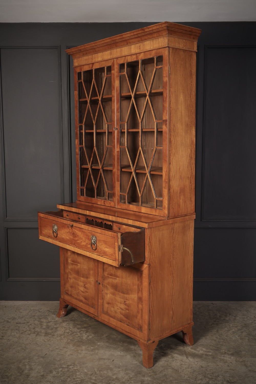 A Georgian satinwood secretaire bookcase with diamond astragal glazed doors above a lower cupboard base. View VIII