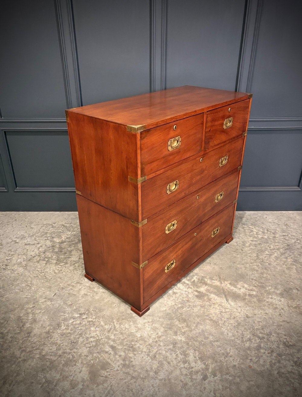 A Victorian two-part mahogany military campaign chest featuring two short over three long drawers with flush brass handles and brass corner straps.