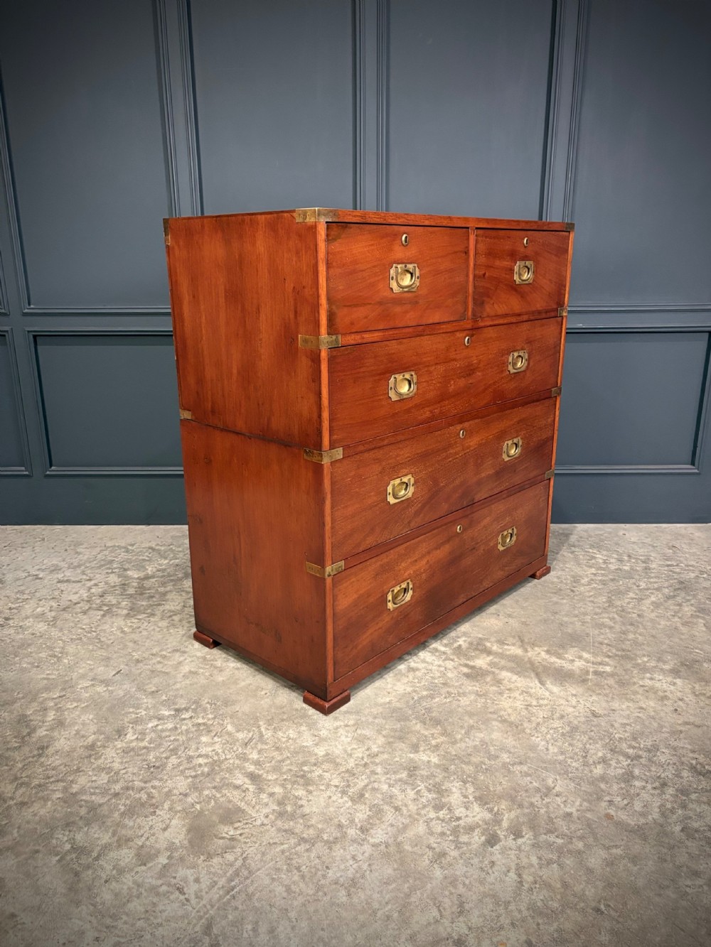 A Victorian two-part mahogany military campaign chest featuring two short over three long drawers with flush brass handles and brass corner straps. View II