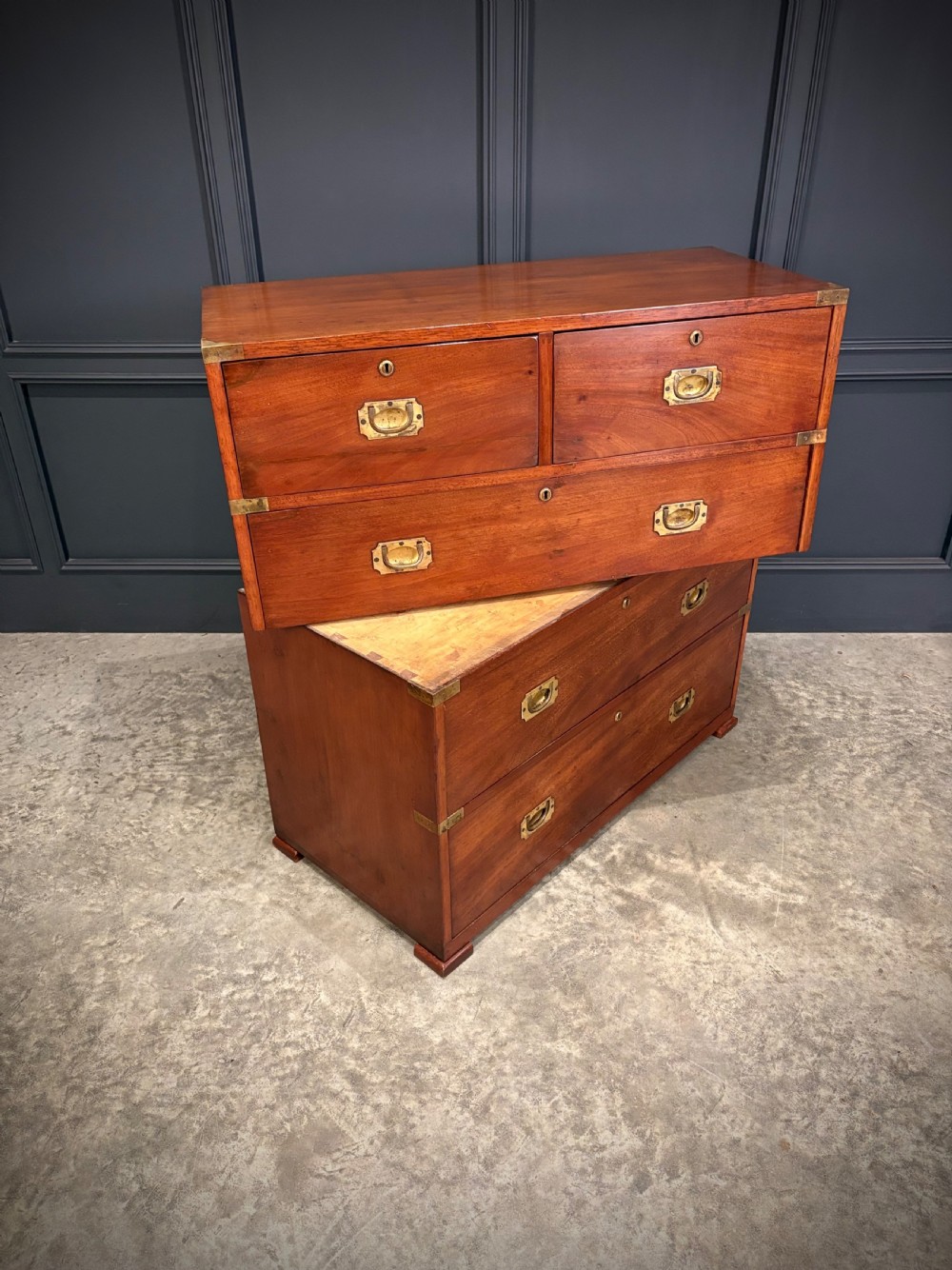 A Victorian two-part mahogany military campaign chest featuring two short over three long drawers with flush brass handles and brass corner straps. View IV