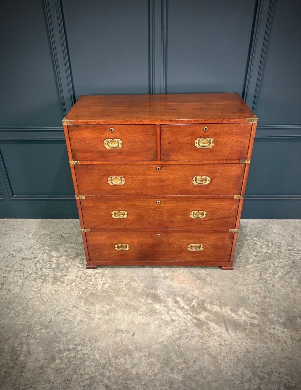A Victorian two-part mahogany military campaign chest featuring two short over three long drawers with flush brass handles and brass corner straps. View V