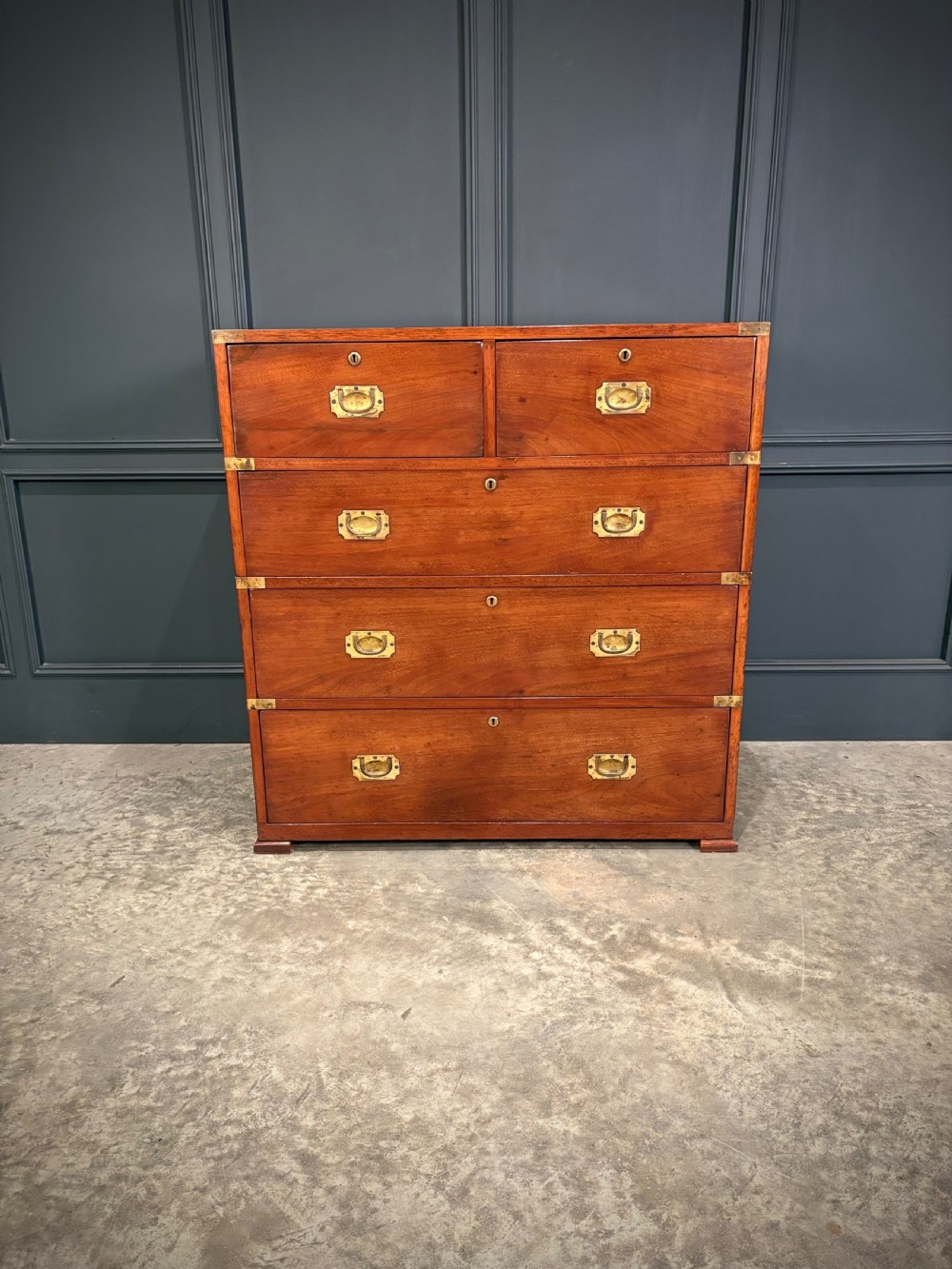 A Victorian two-part mahogany military campaign chest featuring two short over three long drawers with flush brass handles and brass corner straps. View VI