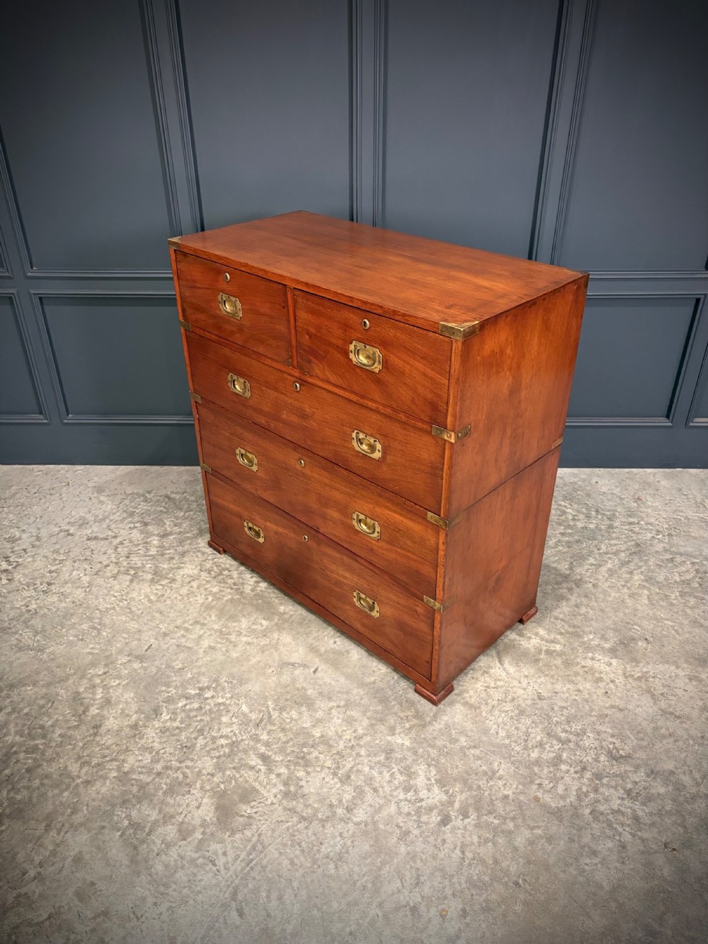 A Victorian two-part mahogany military campaign chest featuring two short over three long drawers with flush brass handles and brass corner straps. View VII