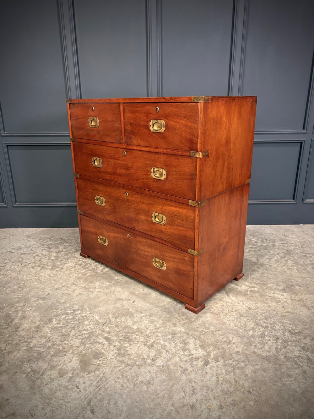 A Victorian two-part mahogany military campaign chest featuring two short over three long drawers with flush brass handles and brass corner straps. View VIII