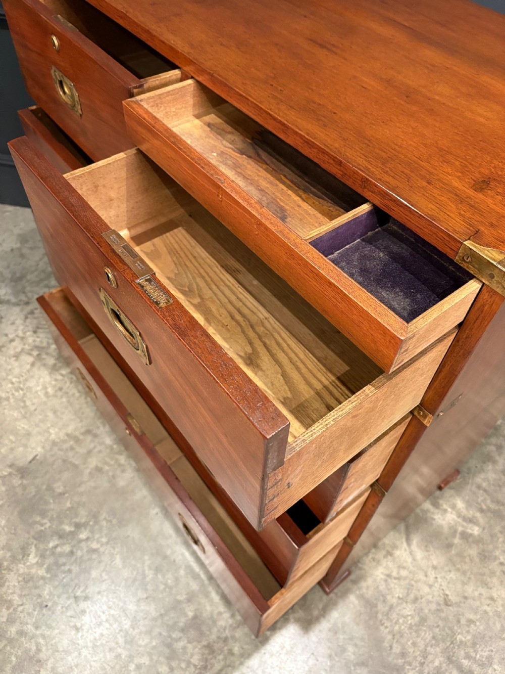 A Victorian two-part mahogany military campaign chest featuring two short over three long drawers with flush brass handles and brass corner straps. View X