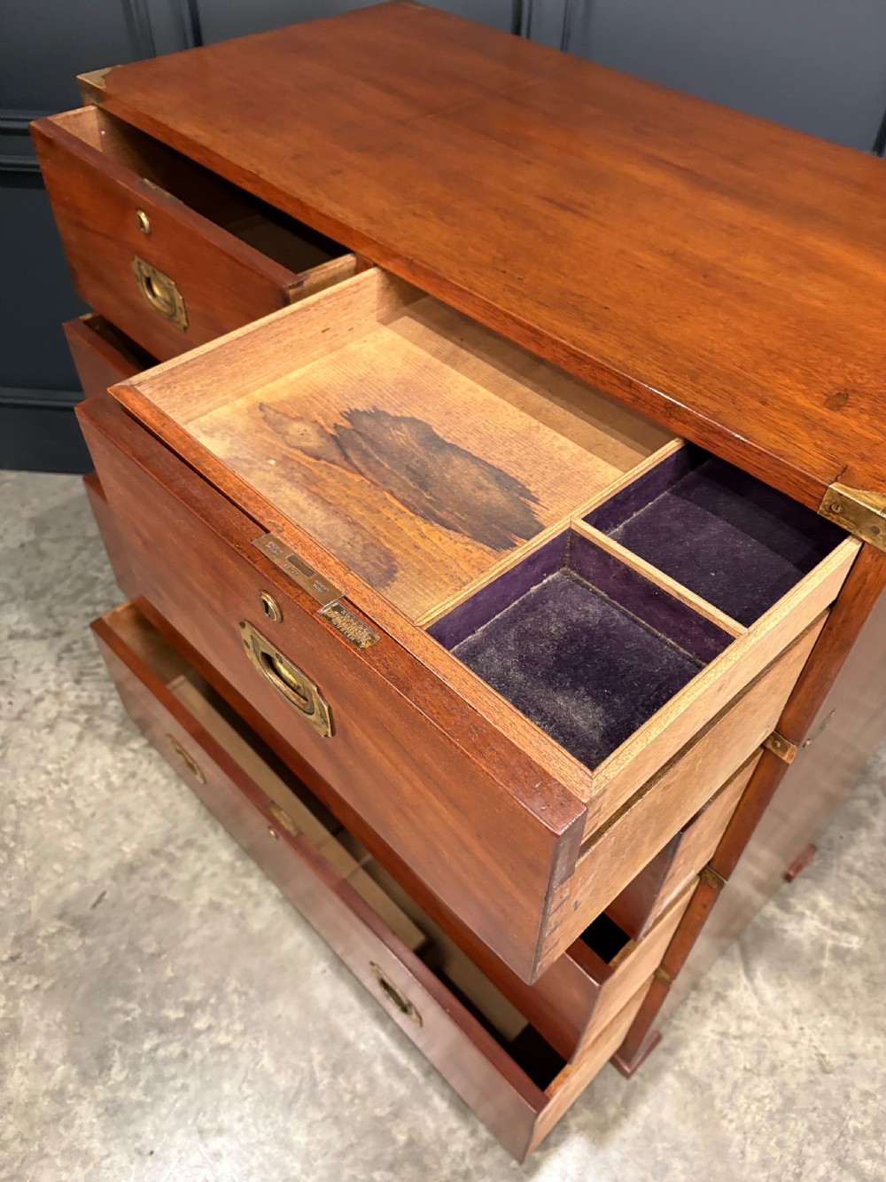 A Victorian two-part mahogany military campaign chest featuring two short over three long drawers with flush brass handles and brass corner straps. View XI