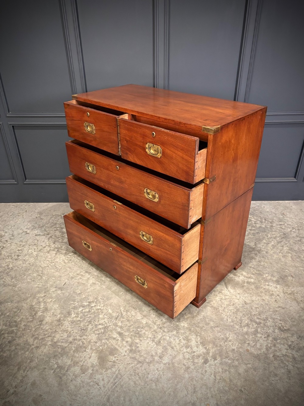 A Victorian two-part mahogany military campaign chest featuring two short over three long drawers with flush brass handles and brass corner straps. View XII