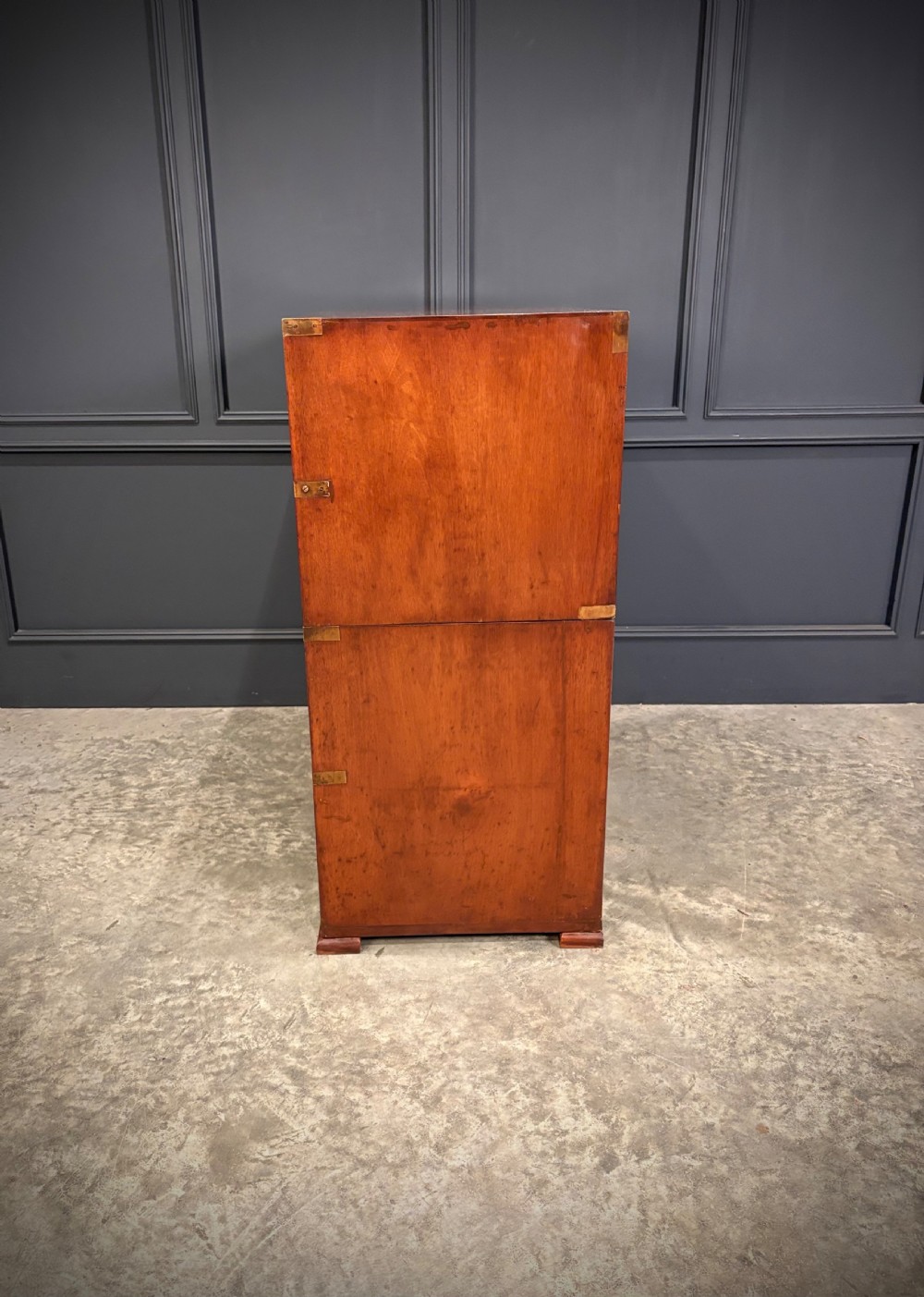 A Victorian two-part mahogany military campaign chest featuring two short over three long drawers with flush brass handles and brass corner straps. View XIII