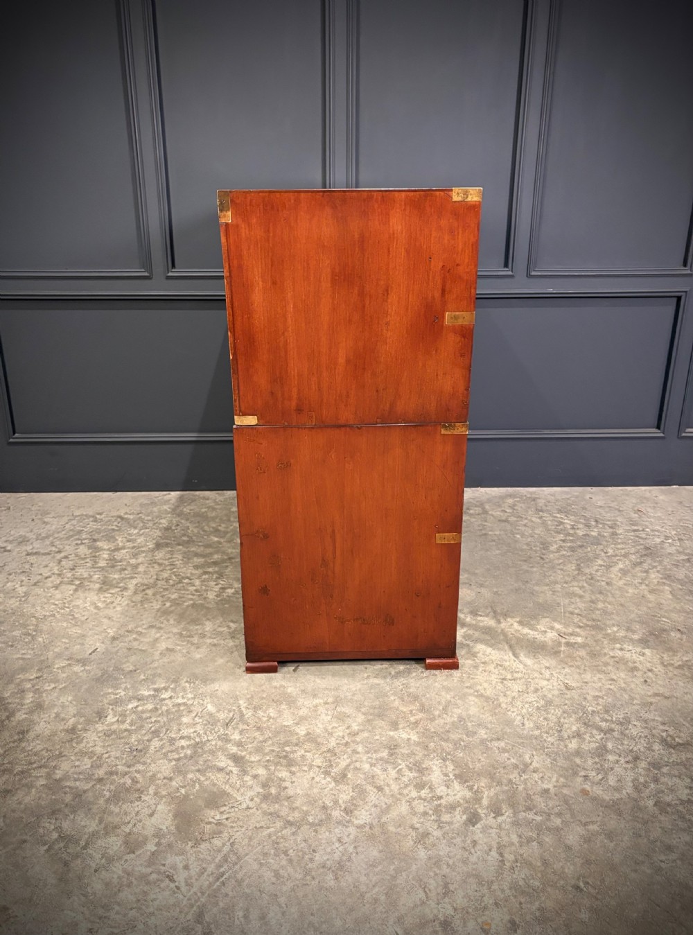A Victorian two-part mahogany military campaign chest featuring two short over three long drawers with flush brass handles and brass corner straps. View XV