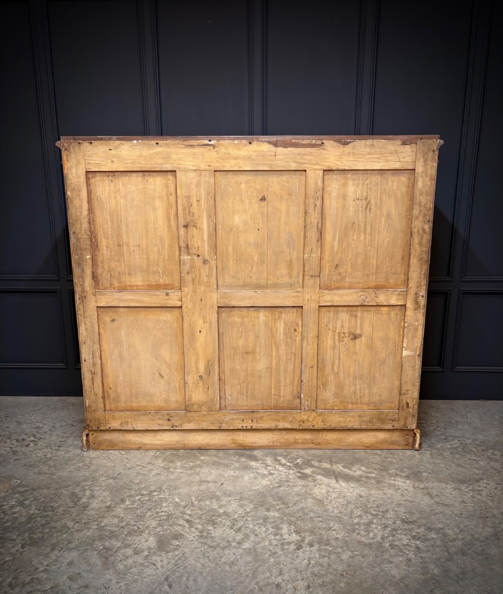 A low Victorian three-door wardrobe crafted from birds eye maple featuring dark wood inlaid borders and turned wooden knobs. View III