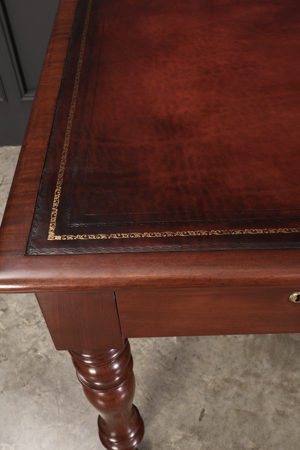 A Victorian mahogany partners writing table with a rich red leather inlaid top, frieze drawers, and turned legs set on brass castors. View V