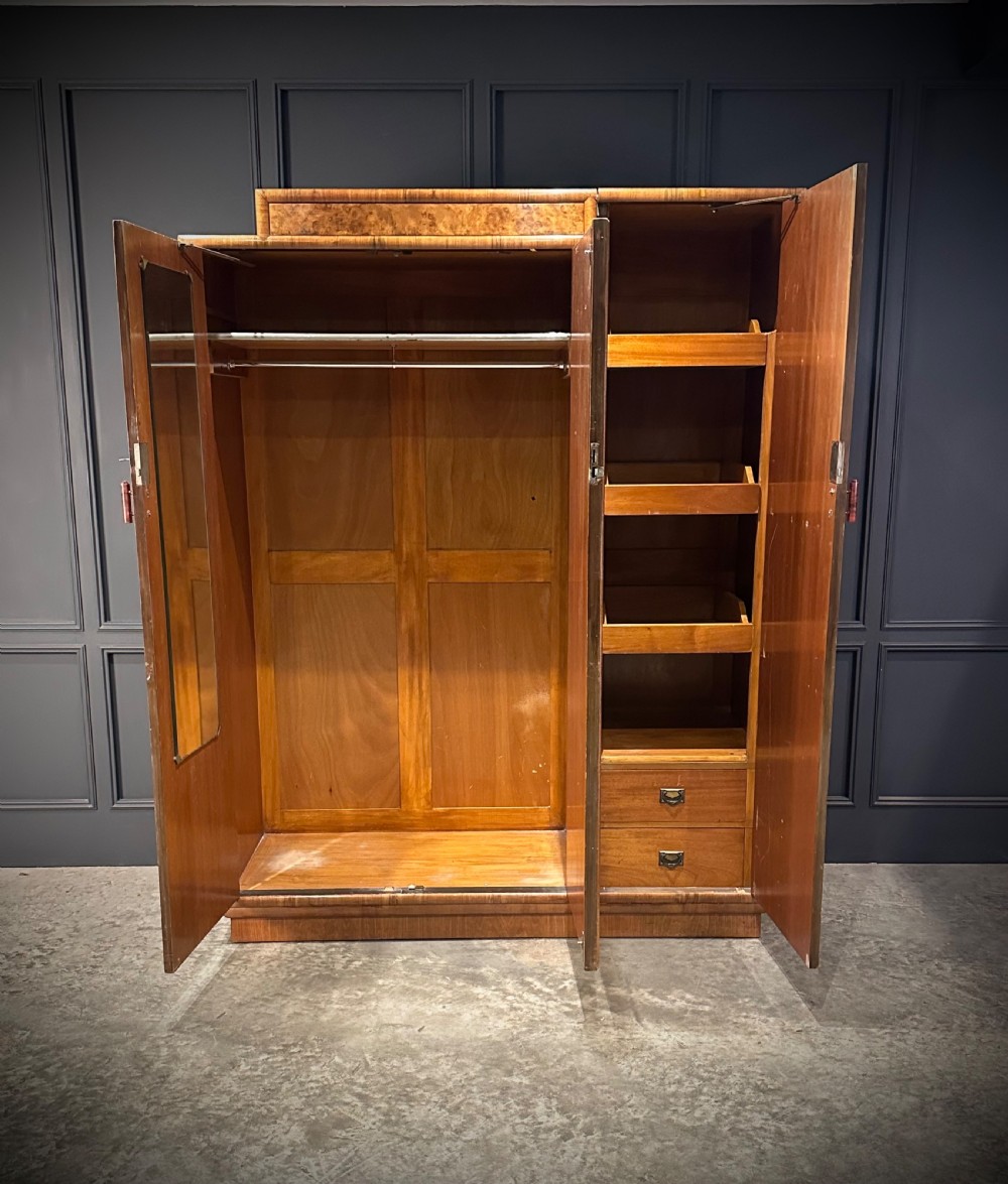 A tall three-door Art Deco wardrobe crafted from figured burr walnut with a stepped top cornice and plinth base. View III