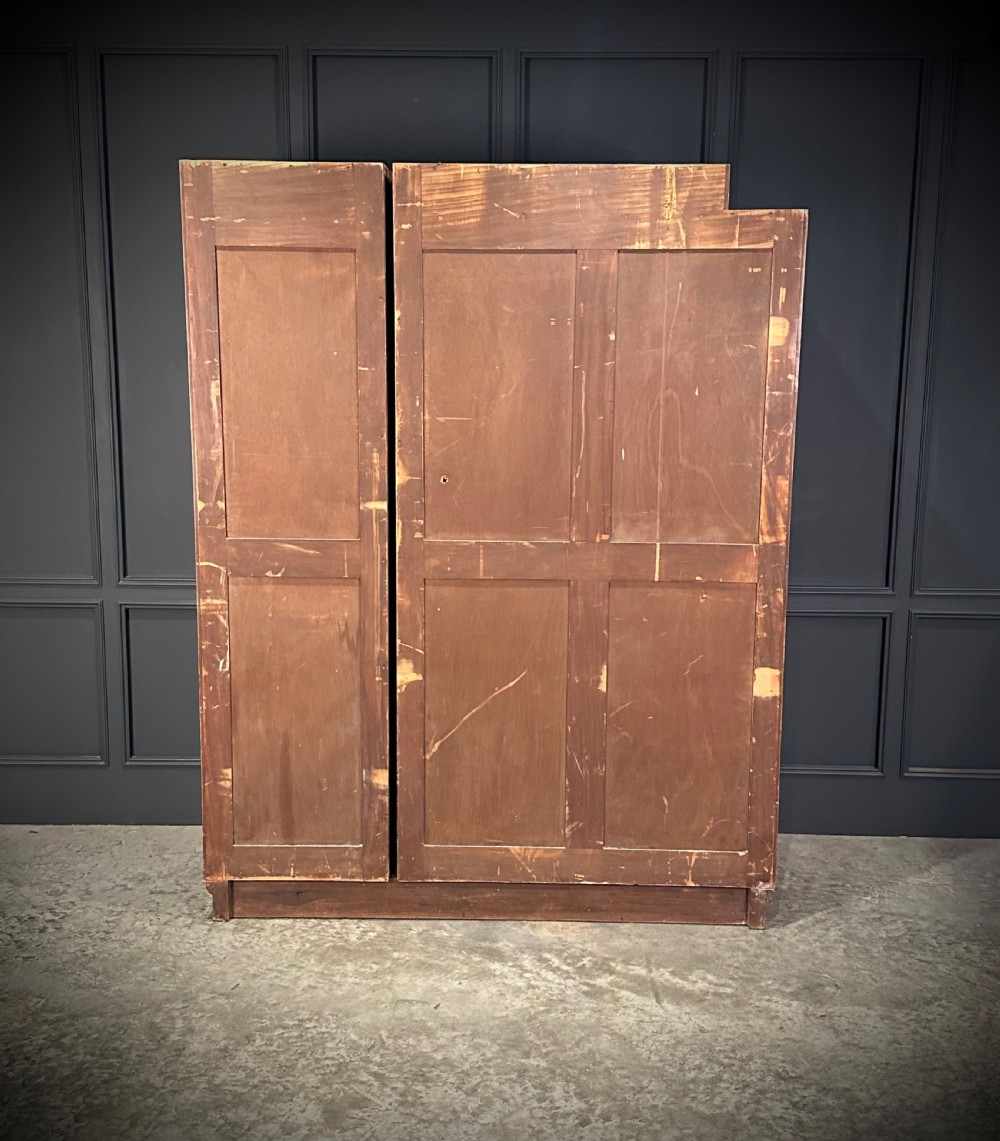 A tall three-door Art Deco wardrobe crafted from figured burr walnut with a stepped top cornice and plinth base. View VII