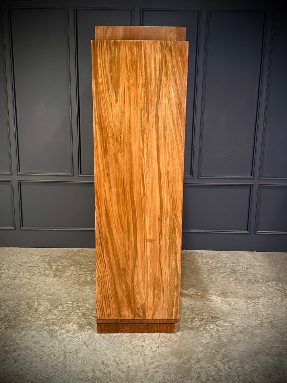 A tall three-door Art Deco wardrobe crafted from figured burr walnut with a stepped top cornice and plinth base. View VIII