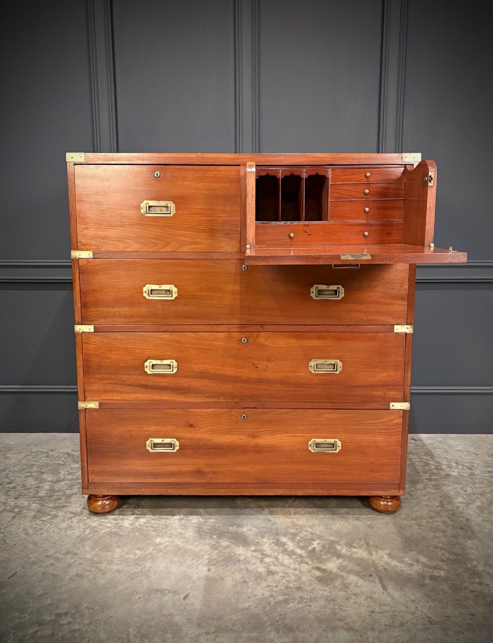 A Victorian mahogany military campaign chest featuring two stackable sections, brass corner brackets, flush recessed handles, and turned bun feet. View II