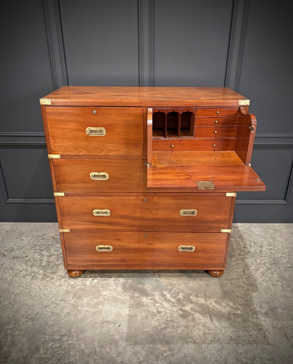 A Victorian mahogany military campaign chest featuring two stackable sections, brass corner brackets, flush recessed handles, and turned bun feet. View III