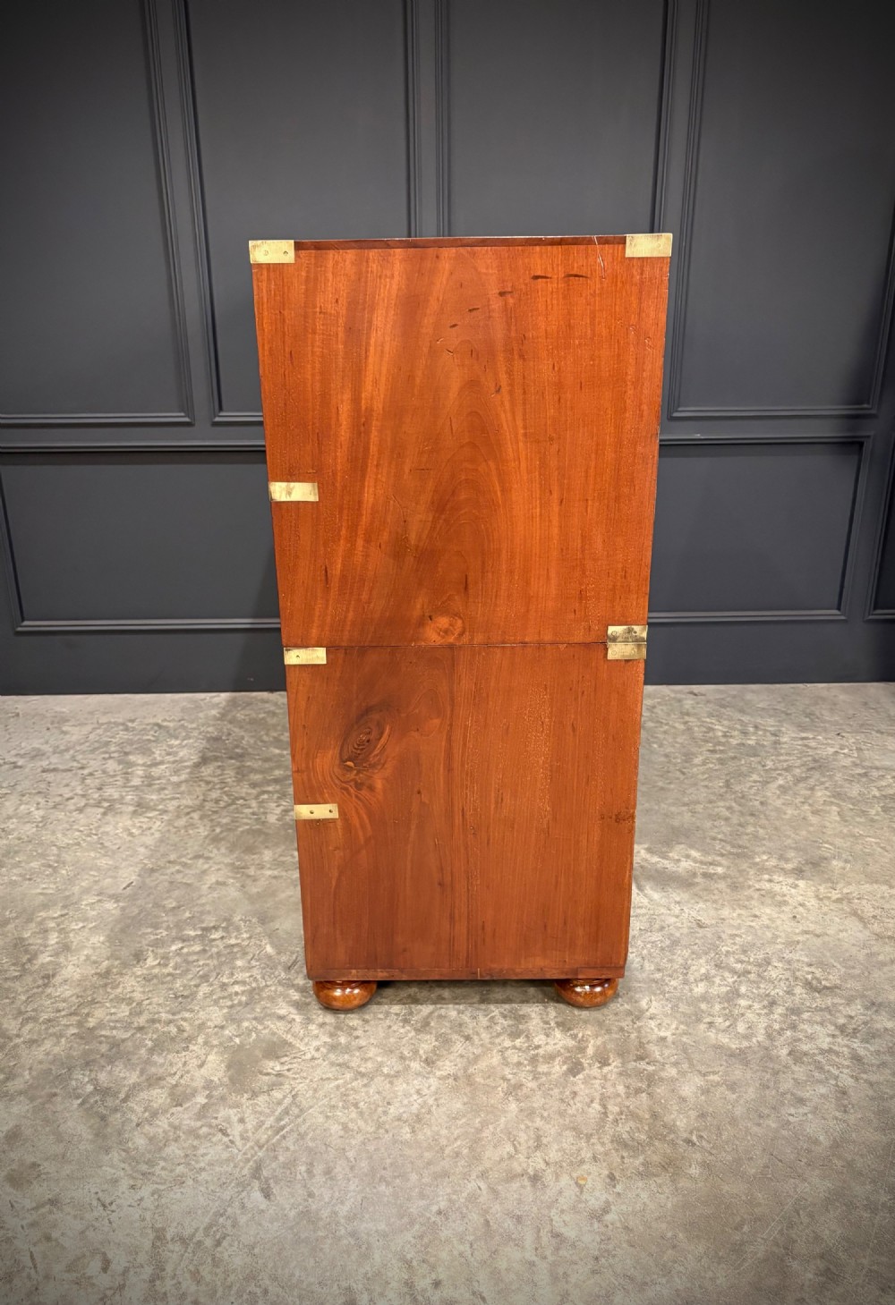 A Victorian mahogany military campaign chest featuring two stackable sections, brass corner brackets, flush recessed handles, and turned bun feet. View X