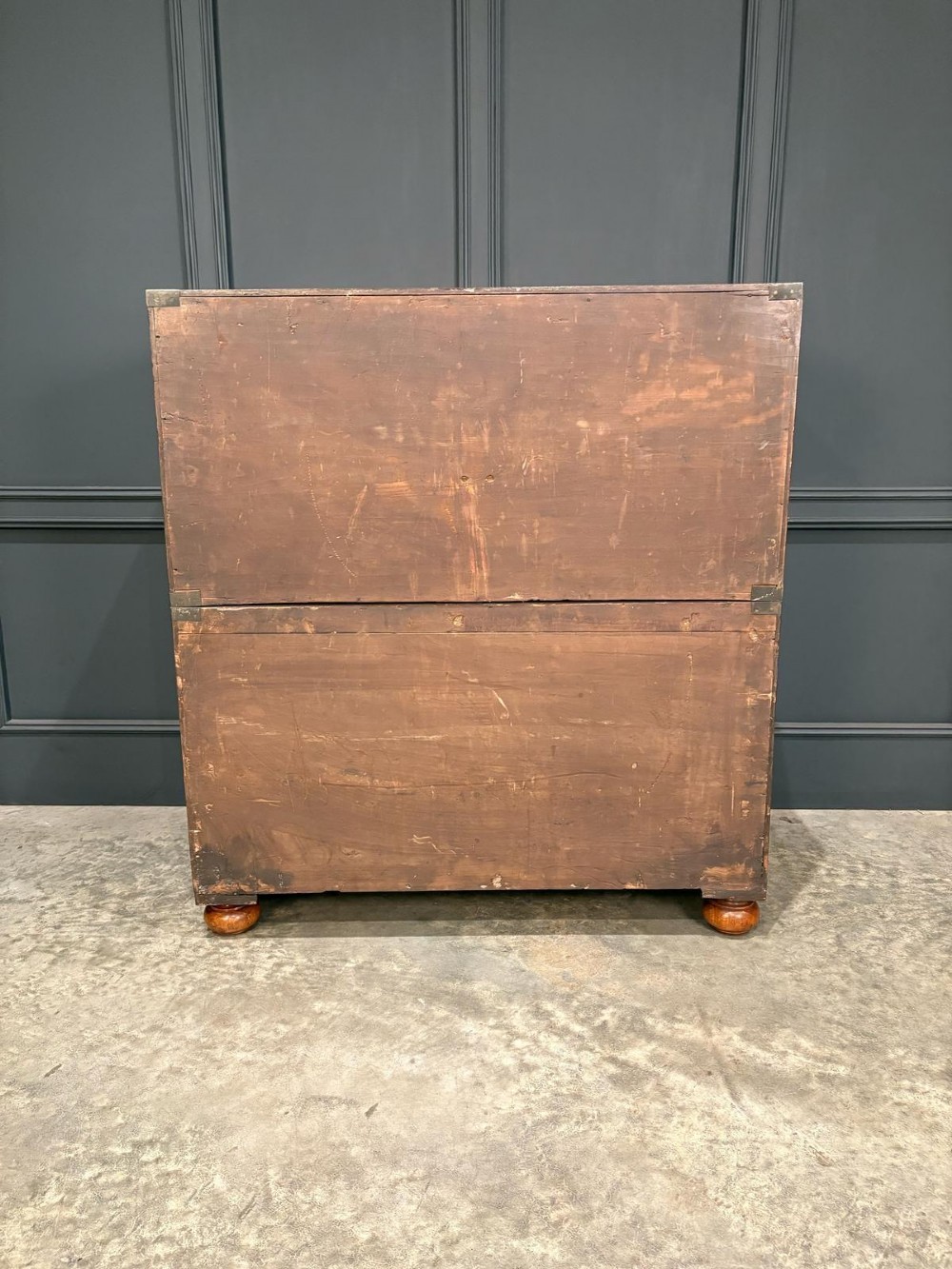 A Victorian mahogany military campaign chest featuring two stackable sections, brass corner brackets, flush recessed handles, and turned bun feet. View XI