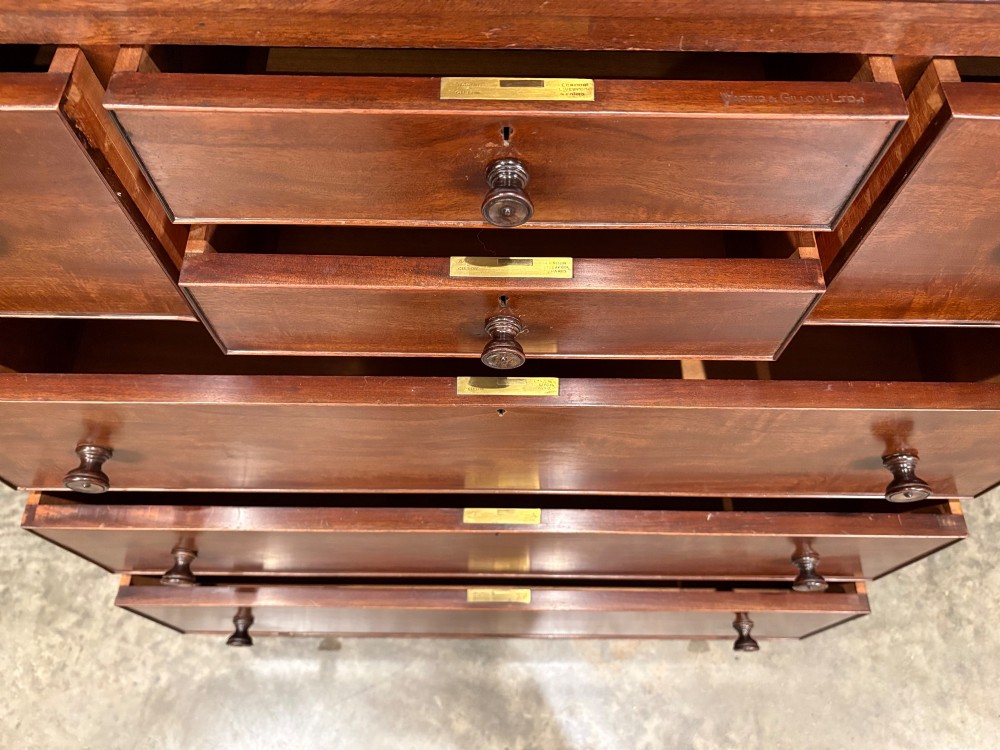 A tall antique mahogany chest of drawers featuring an upper arrangement of small drawers over three graduated full-width drawers, resting on bracket feet. View VIII