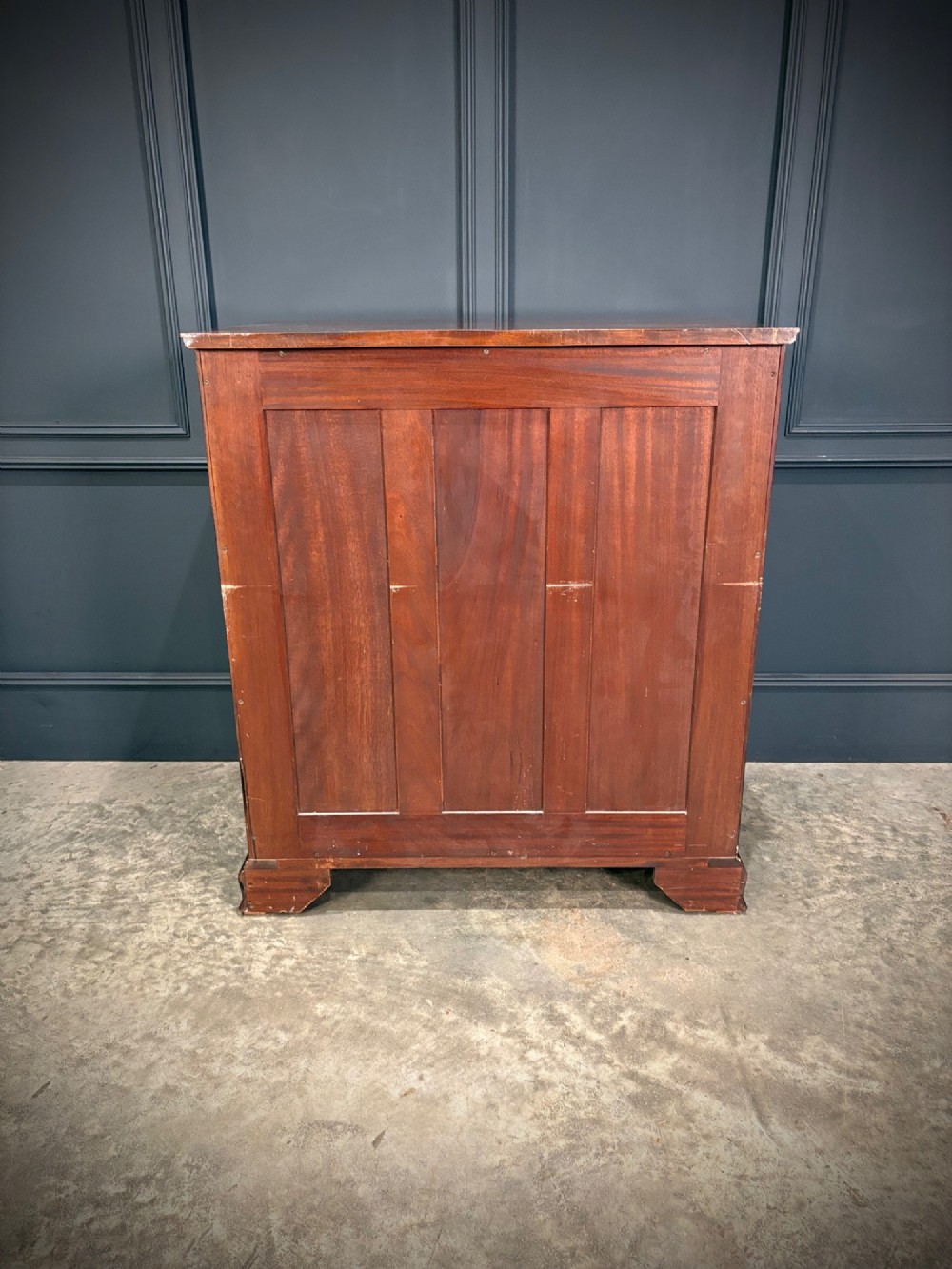A tall antique mahogany chest of drawers featuring an upper arrangement of small drawers over three graduated full-width drawers, resting on bracket feet. View XIII