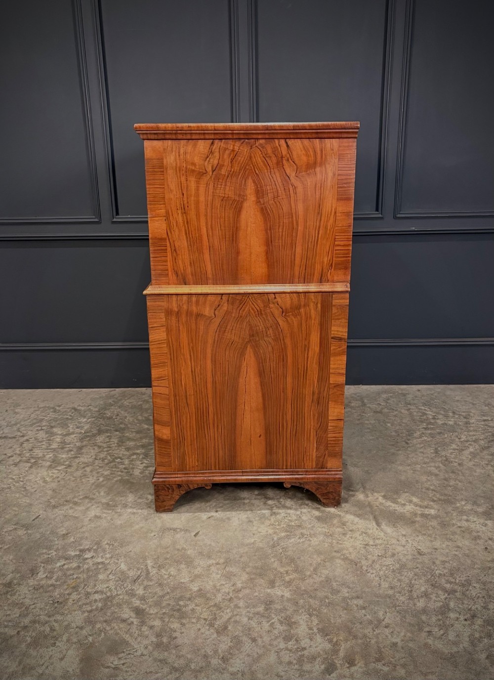 An antique walnut cabinet on chest featuring a twin-door top cupboard over graduating drawers with brass hardware and bracket feet. View IX
