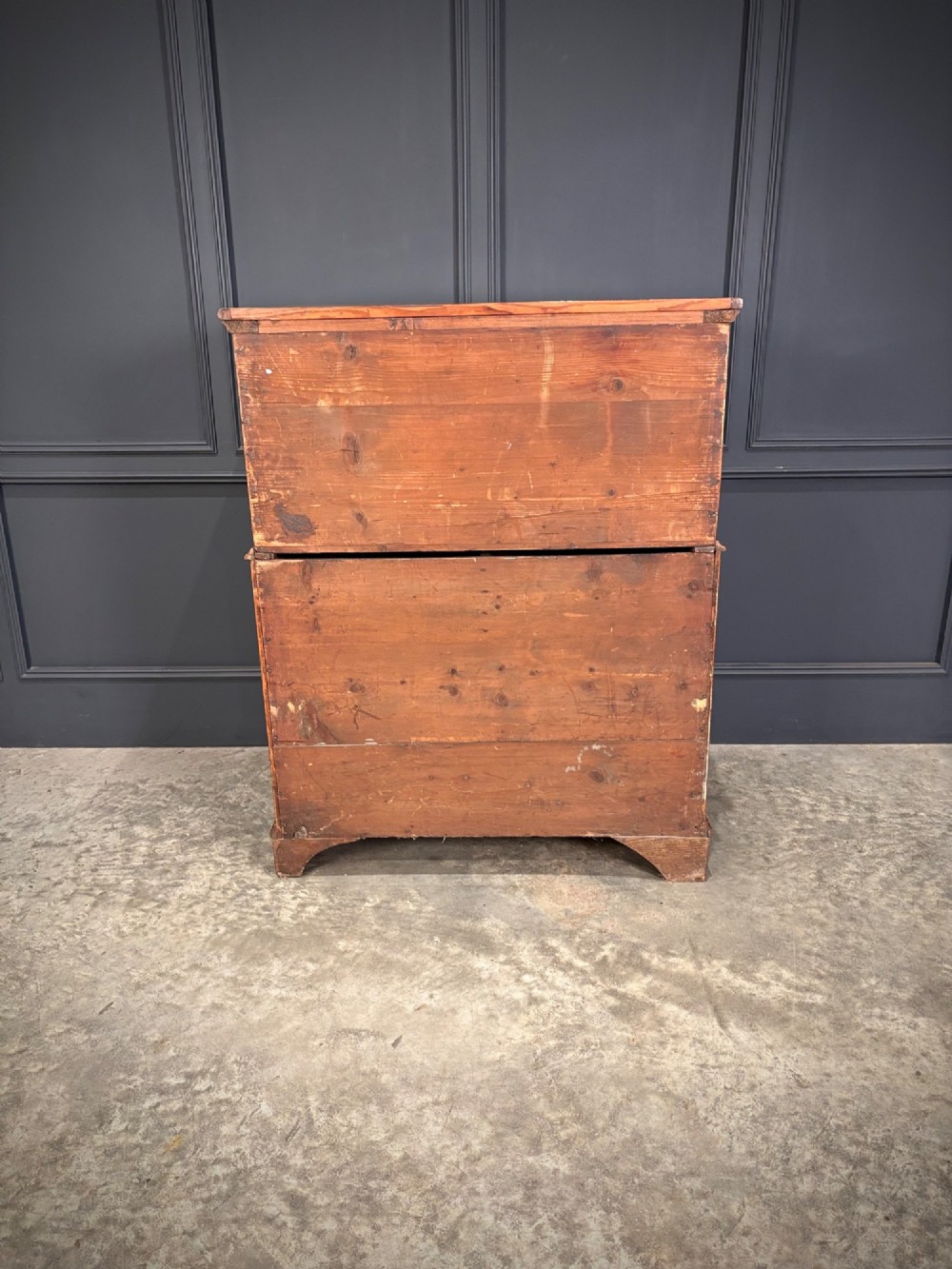 An antique walnut cabinet on chest featuring a twin-door top cupboard over graduating drawers with brass hardware and bracket feet. View X