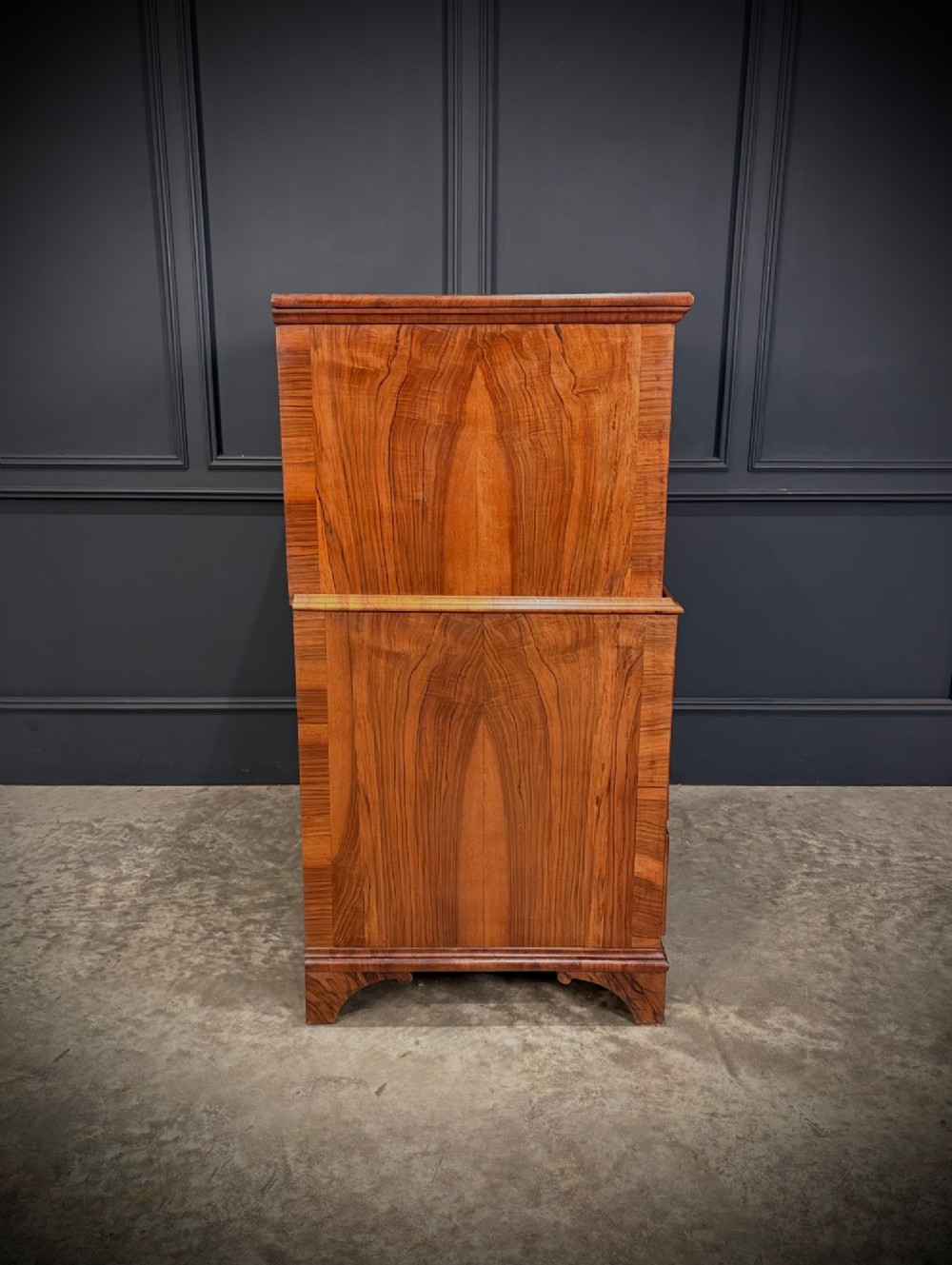 An antique walnut cabinet on chest featuring a twin-door top cupboard over graduating drawers with brass hardware and bracket feet. View XI