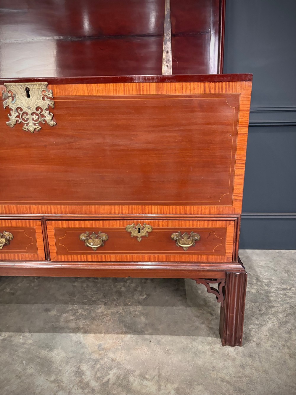 A Georgian inlaid mahogany silver chest on stand featuring satinwood crossbanding, brass side carrying handles, two lower drawers, and square legs with bracket corner supports. View VIII