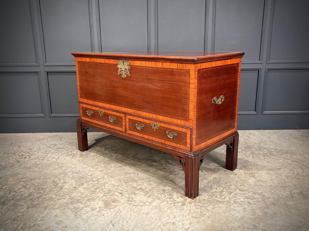 A Georgian inlaid mahogany silver chest on stand featuring satinwood crossbanding, brass side carrying handles, two lower drawers, and square legs with bracket corner supports. View XI