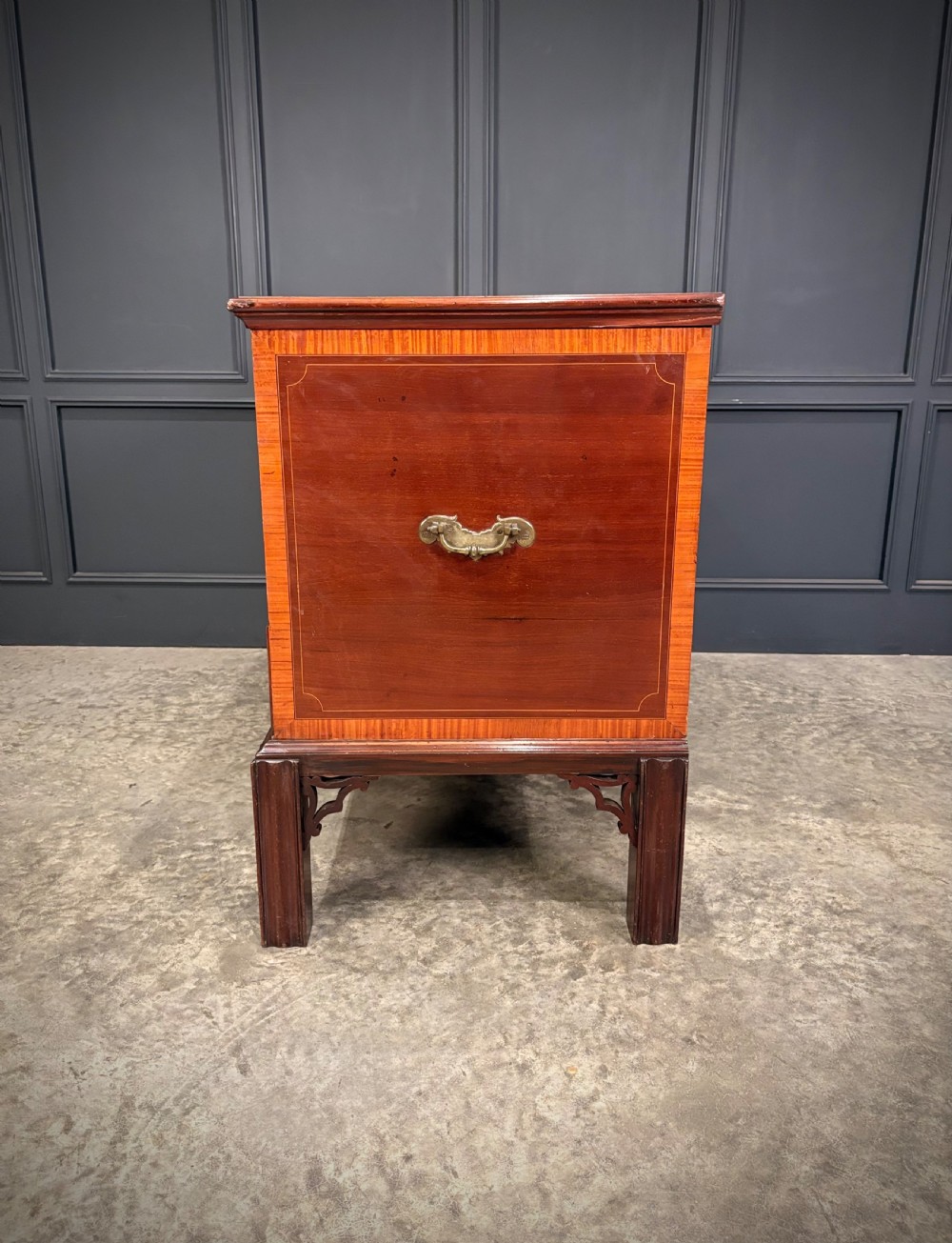 A Georgian inlaid mahogany silver chest on stand featuring satinwood crossbanding, brass side carrying handles, two lower drawers, and square legs with bracket corner supports. View XIV