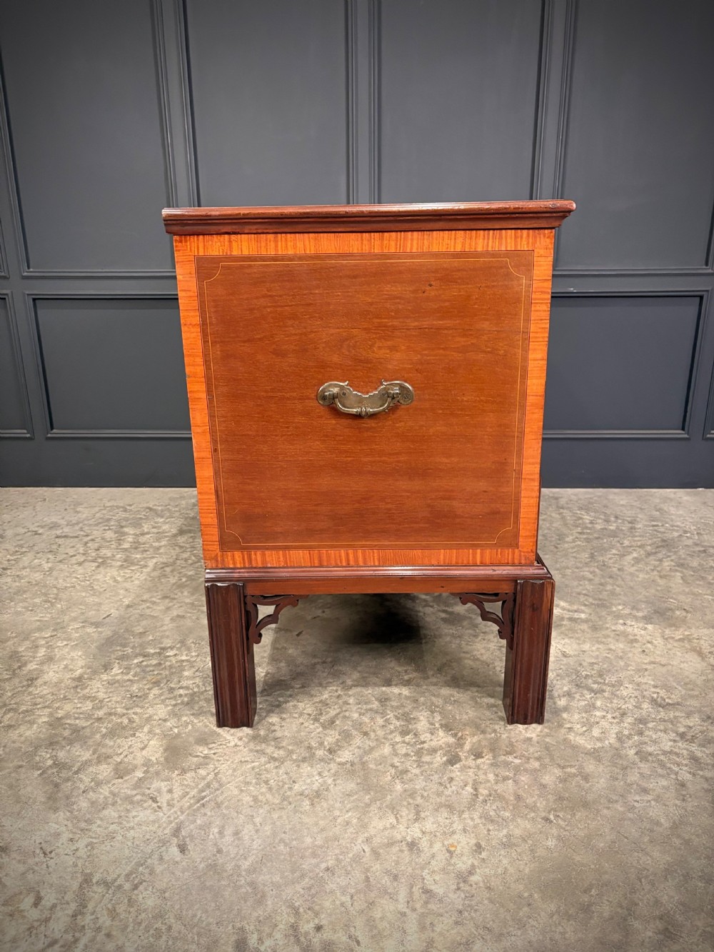 A Georgian inlaid mahogany silver chest on stand featuring satinwood crossbanding, brass side carrying handles, two lower drawers, and square legs with bracket corner supports. View XVI