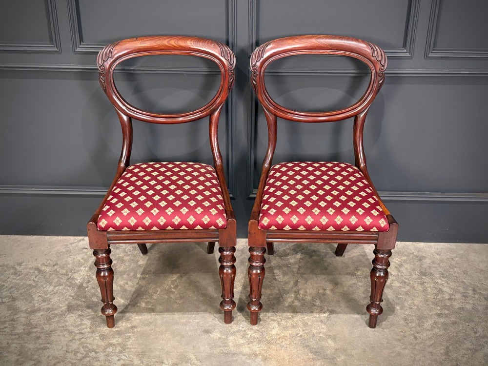 A pair of Victorian mahogany side chairs with rounded balloon backs, turned front legs, and red patterned fabric seats. View III