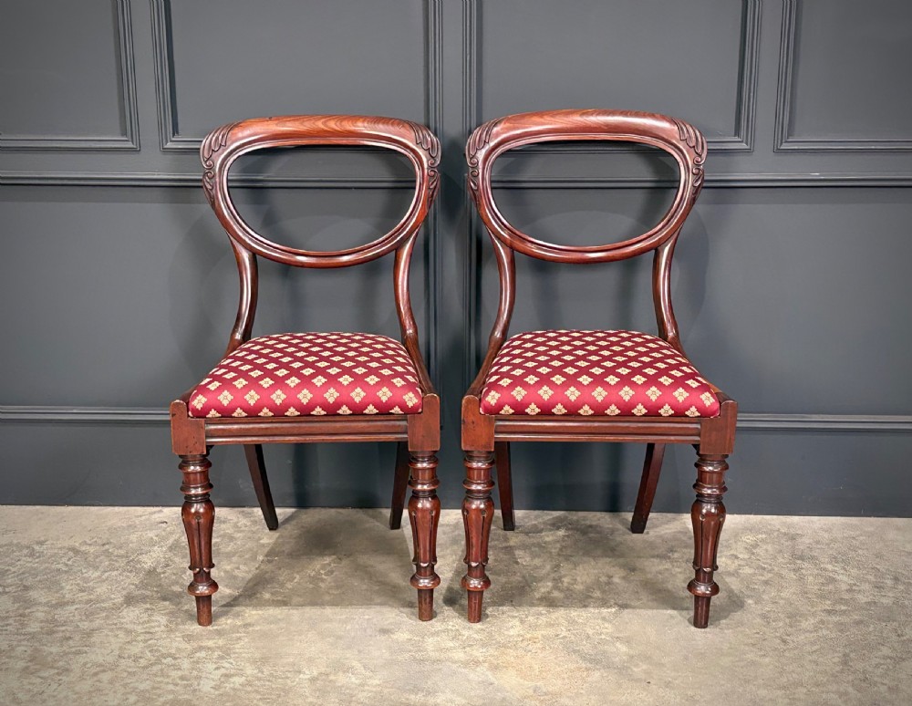 A pair of Victorian mahogany side chairs with rounded balloon backs, turned front legs, and red patterned fabric seats. View IV