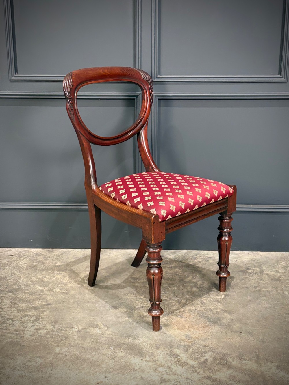 A pair of Victorian mahogany side chairs with rounded balloon backs, turned front legs, and red patterned fabric seats. View VII